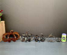 Load image into Gallery viewer, Pumpkins arranged by size (Left to right: Large Horseshoe Pumpkin (no longer available), Regular Horseshoe Pumpkin, Small/Pony Horseshoe Pumpkin, Rod Pumpkin, Horseshoe Nail Pumpkin, Can for scale)
